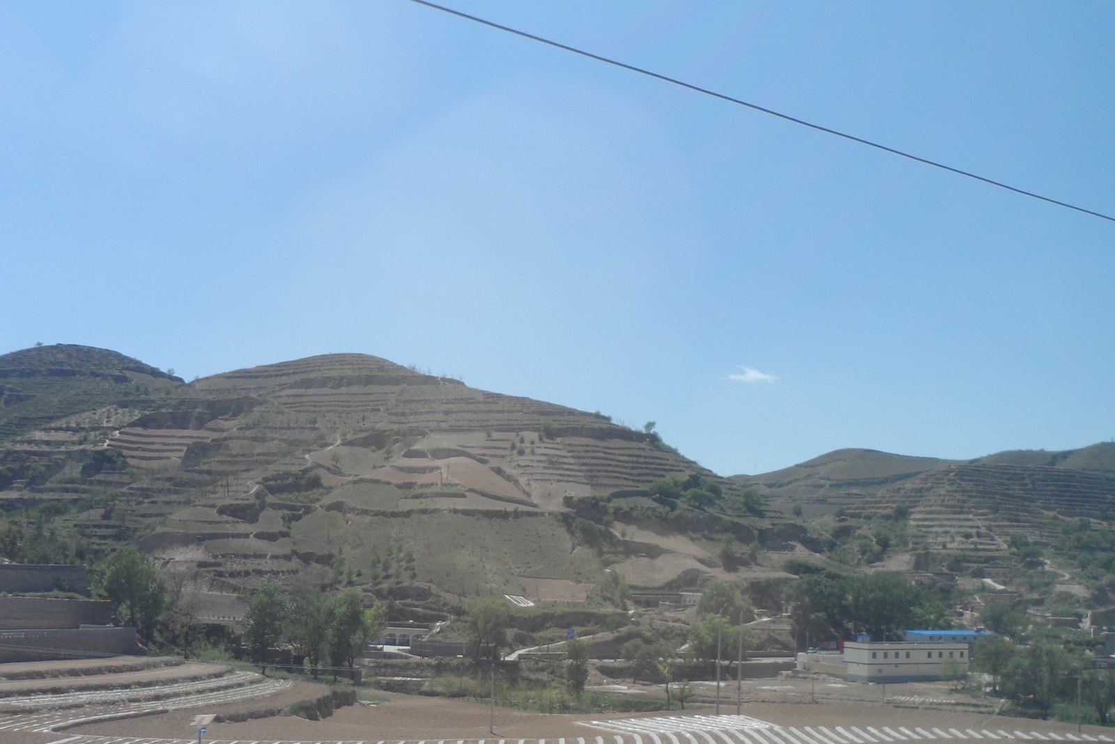Terraced loess hills in Shanxi: the class of slope-to-terrace work the World Bank projects funded, not a proof that the whole plateau is greened