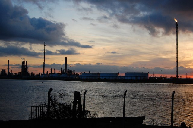 An oil refinery at dusk — the class of industrial site emissions inventories try to measure from space
