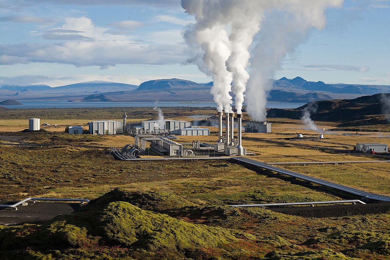 Nesjavellir geothermal power plant in Iceland: steam pipes and halls on a mossy lava field by a lake