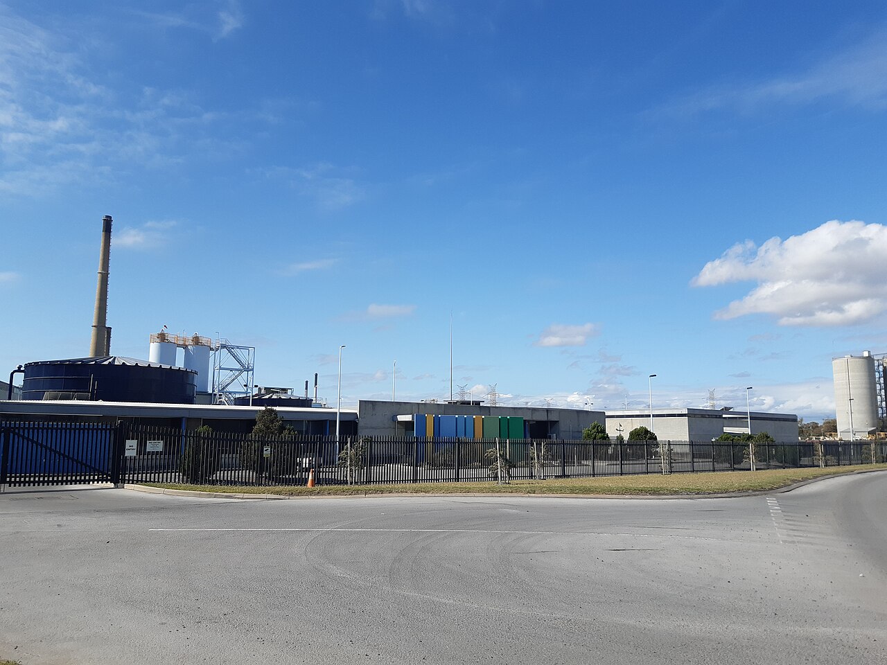 Perth Seawater Desalination Plant beside a fenced access road under a blue sky