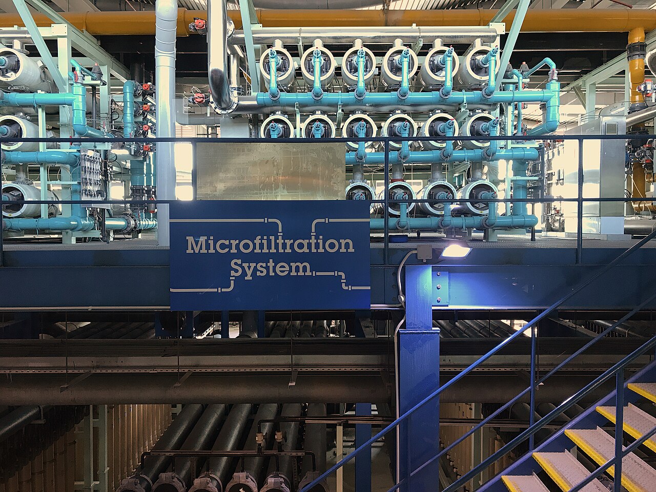 Blue microfiltration vessels and pipes labeled Microfiltration System at Bedok NEWater Factory
