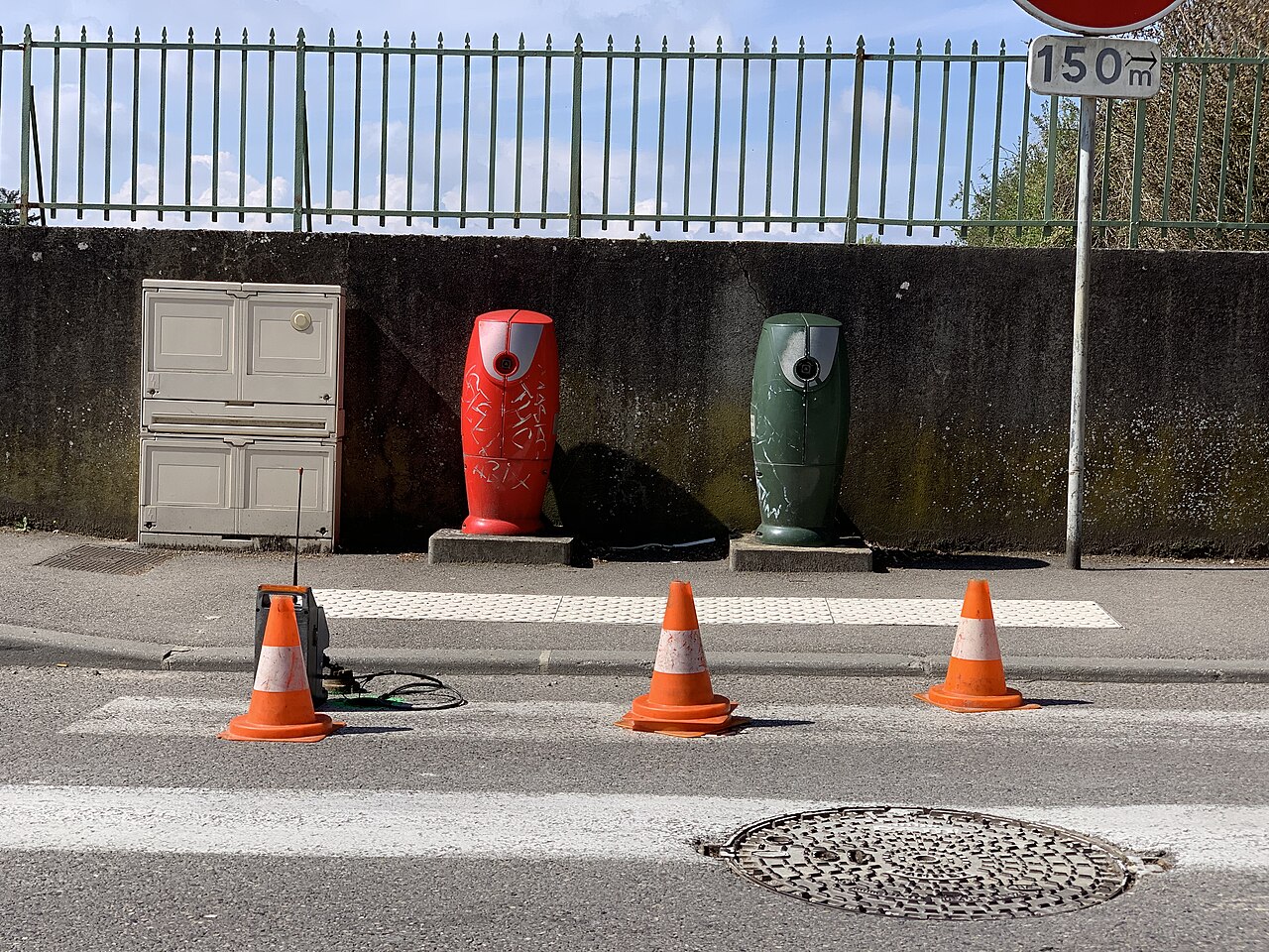 A technician listens for a leak on a street water main in Saint-Maurice-de-Beynost with a correlator and a ground microphone