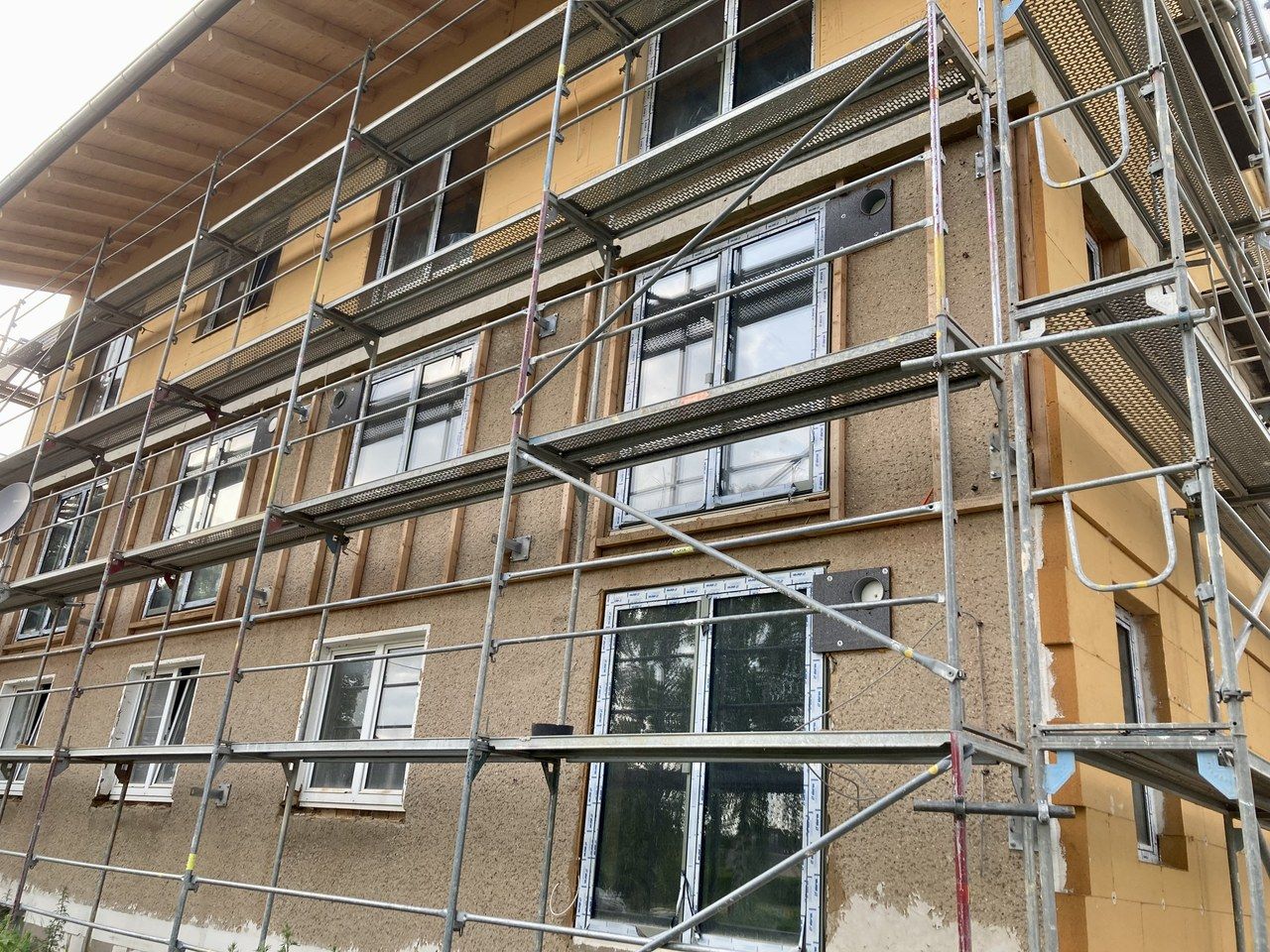 Wood fibre insulation boards on a building facade under scaffolding in Lotschen, Blankenhain, Germany.